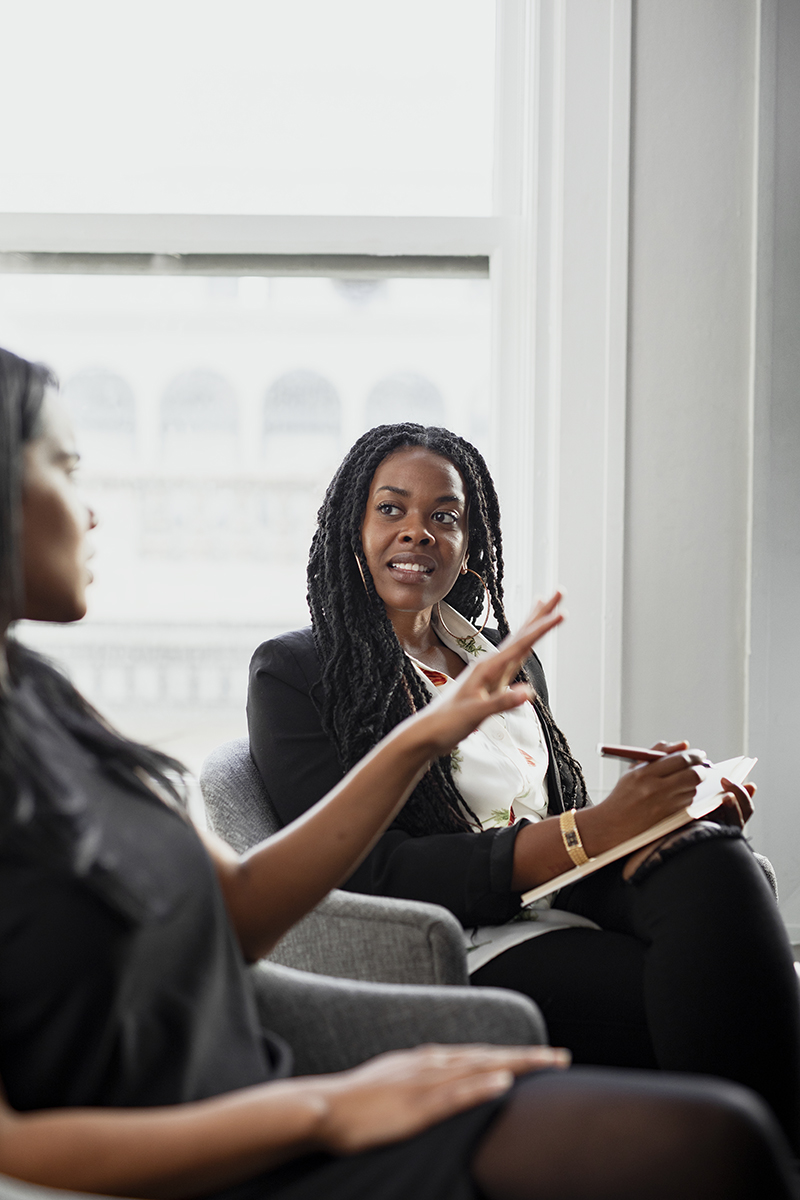 Black woman with a notepad in a meeting